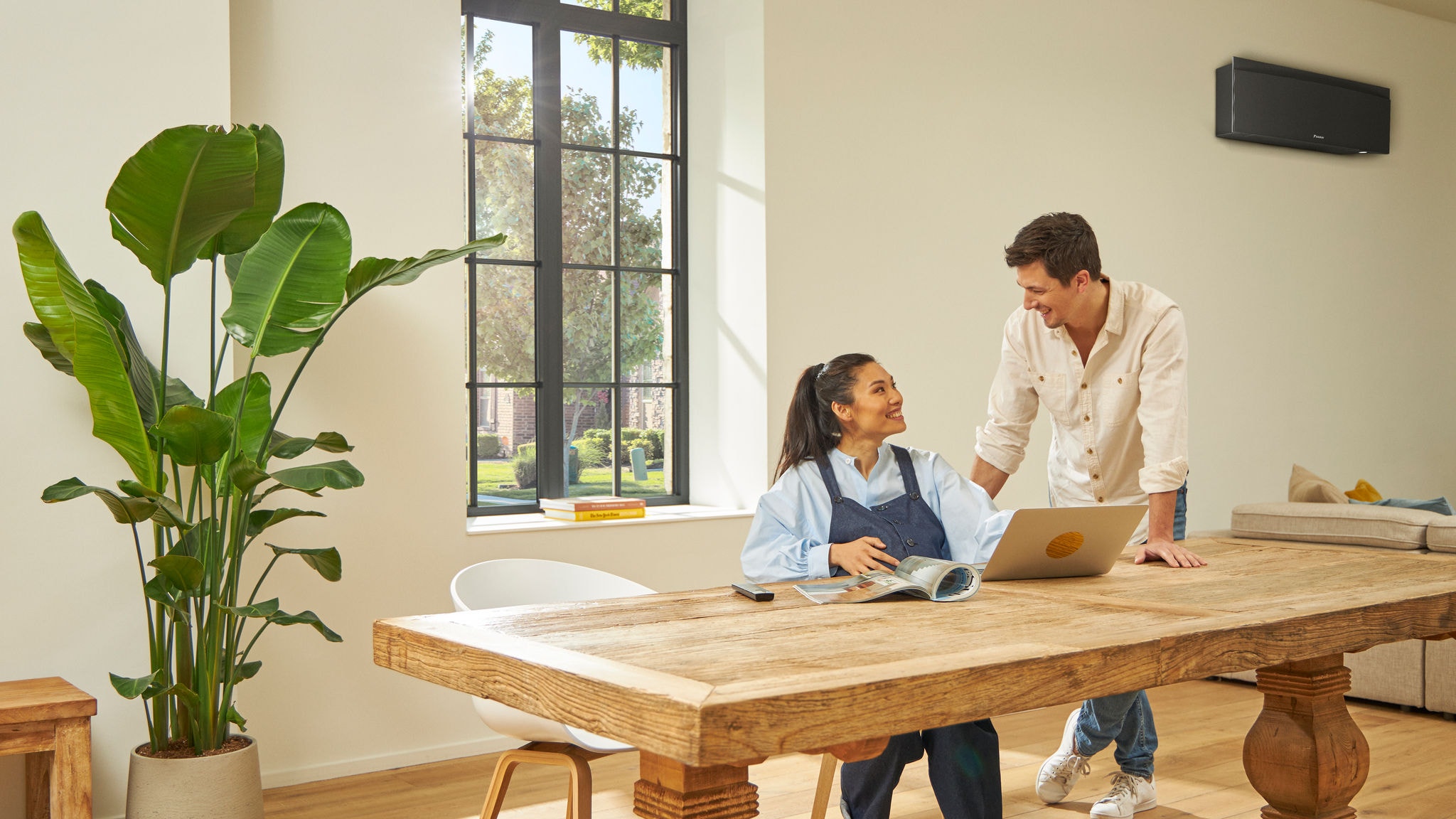 Couple laughing while sitting at a table