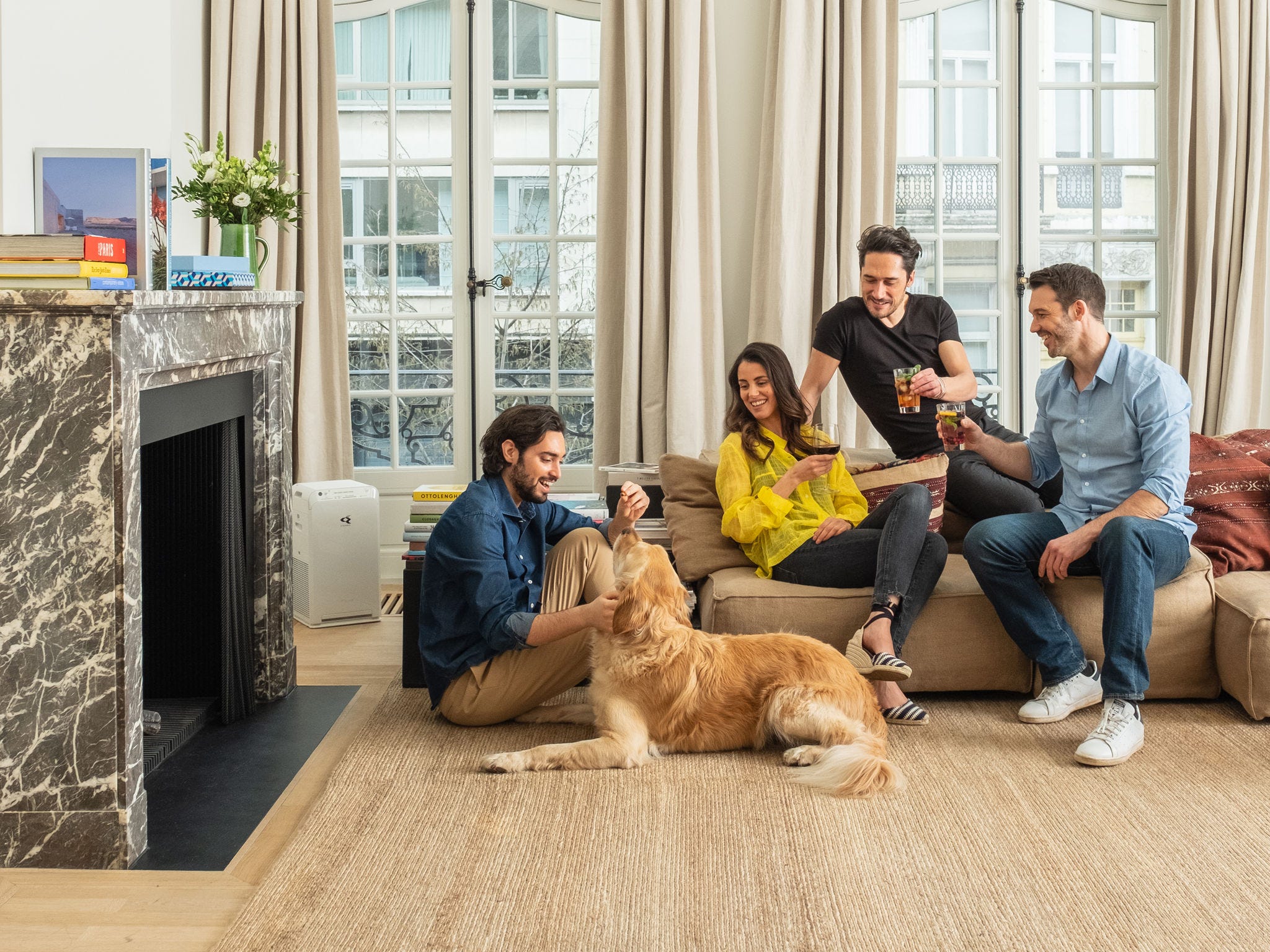 Father and son petting their dog not worried about pet hair thanks to the air purifier