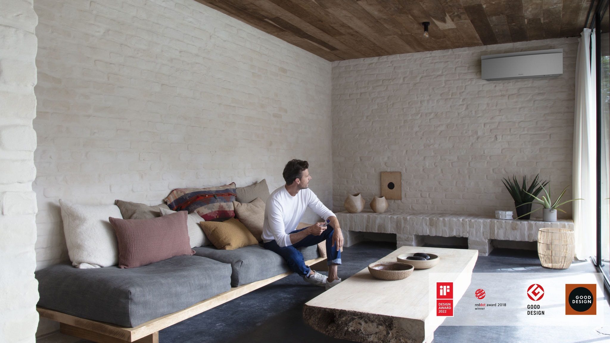 Man controlling his air conditioner in the living room with a remote