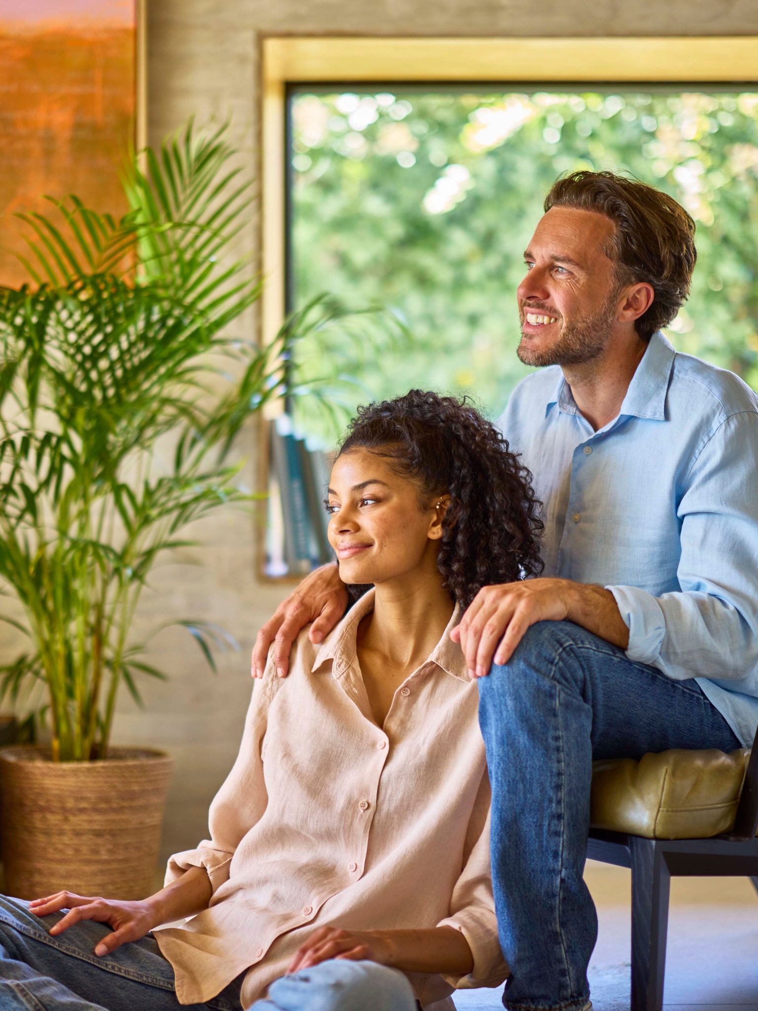 Couple relaxing comfortably in a warm living room heated by a heat pump