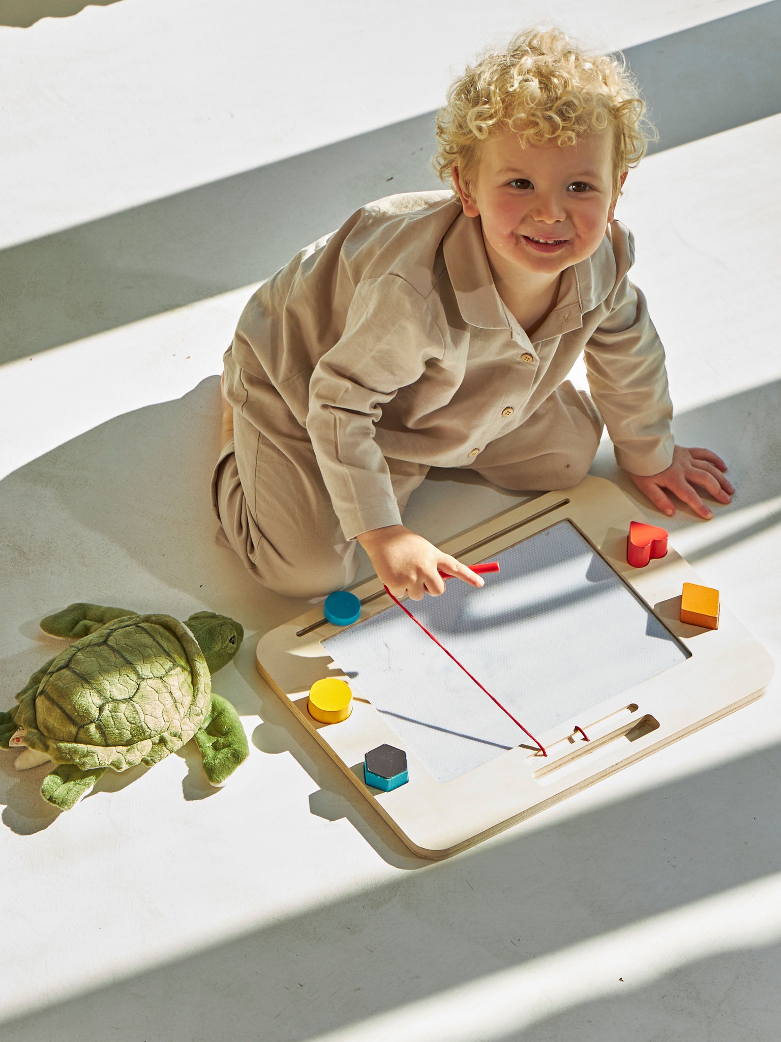 Little boy playing on the ground enjoying underfloor heating