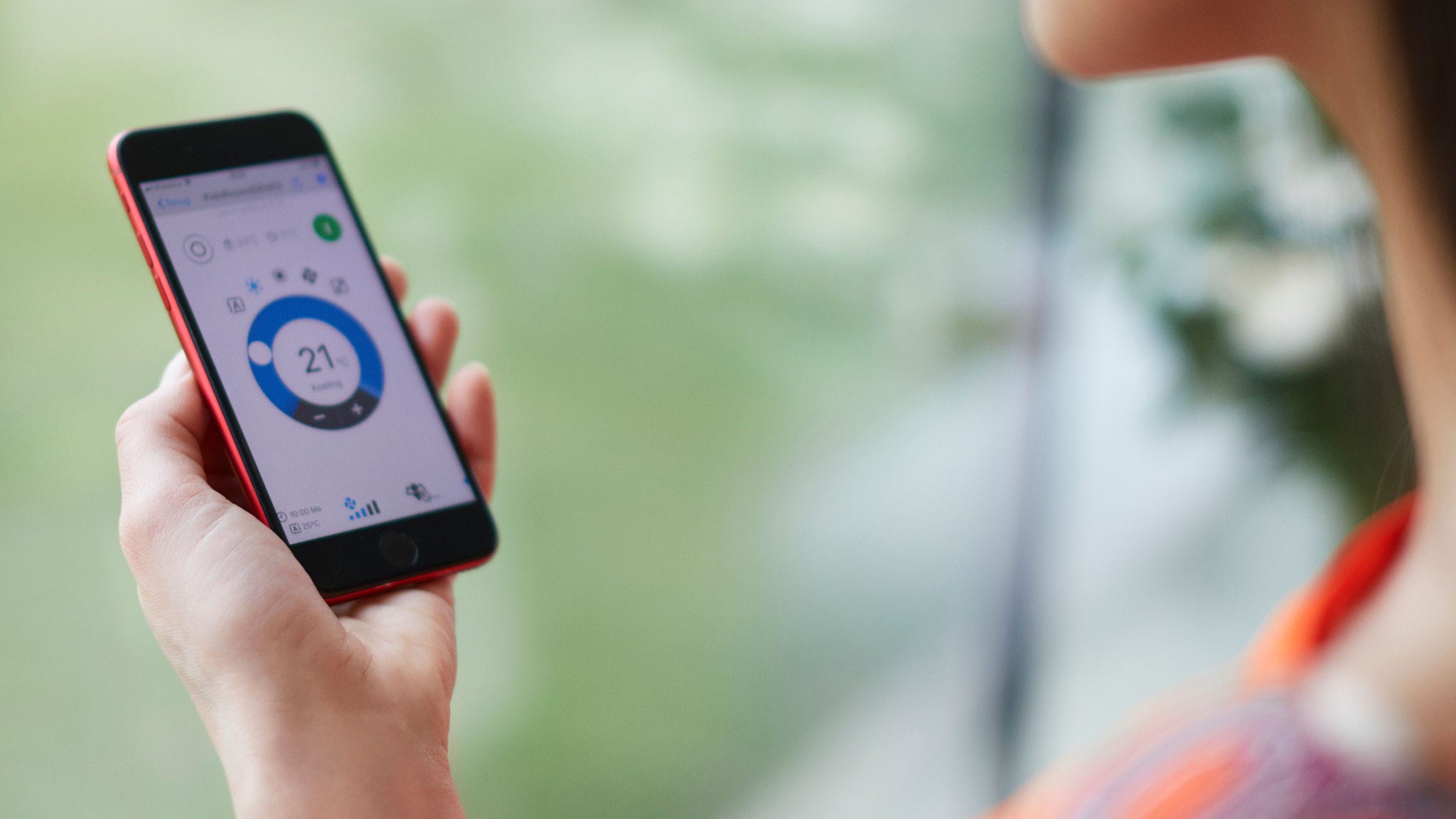 Woman using an app to control her heating solution
