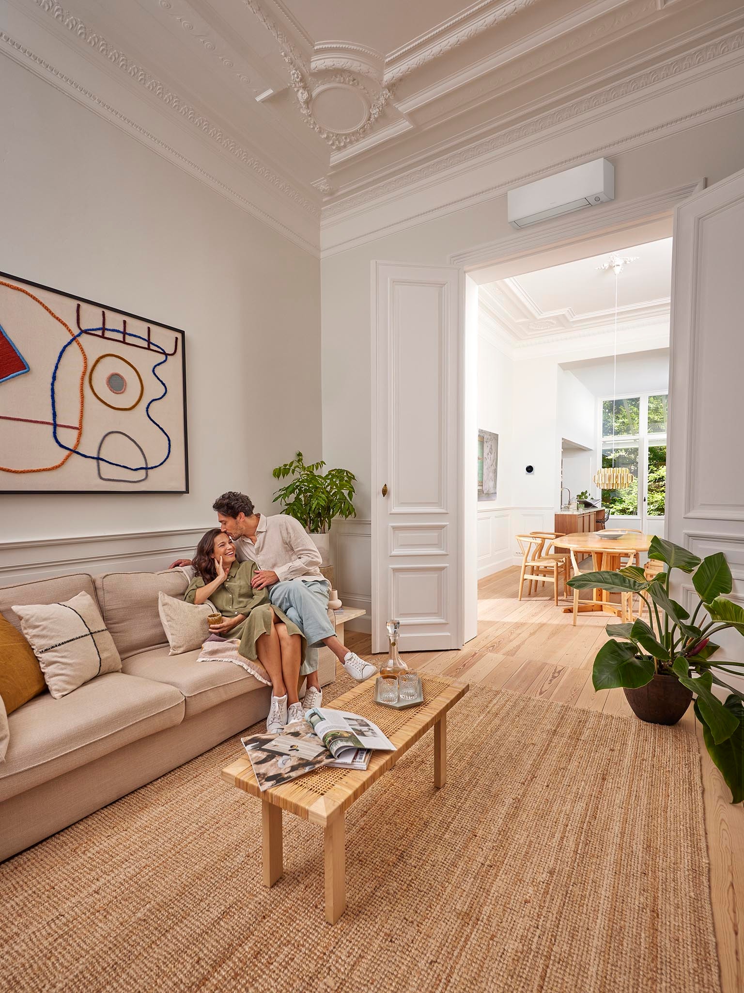 Couple relaxing indoors with inverter air conditioner providing comfort