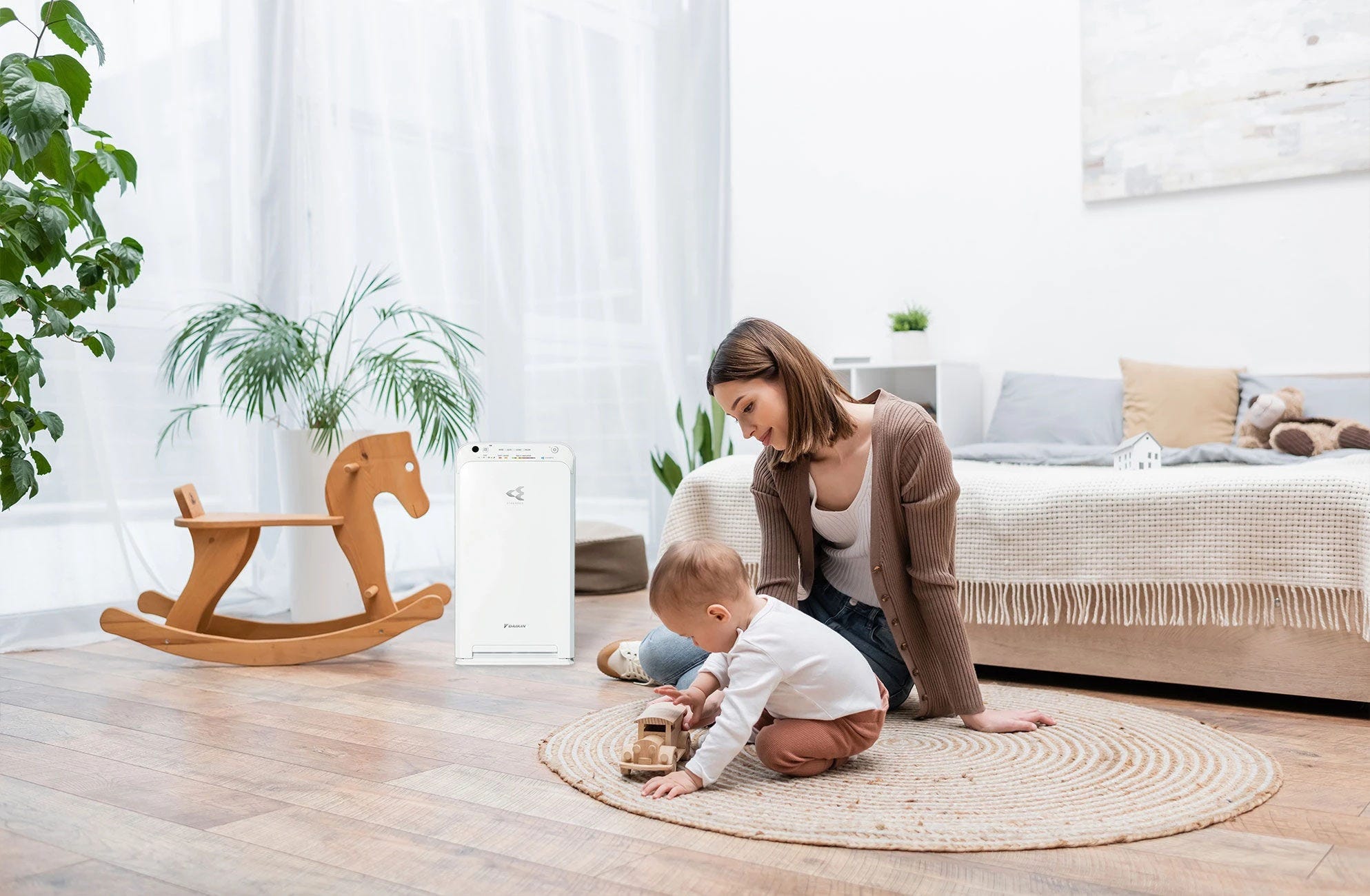 Father tucking in his baby in a peaceful nursery with an air purifier nearby