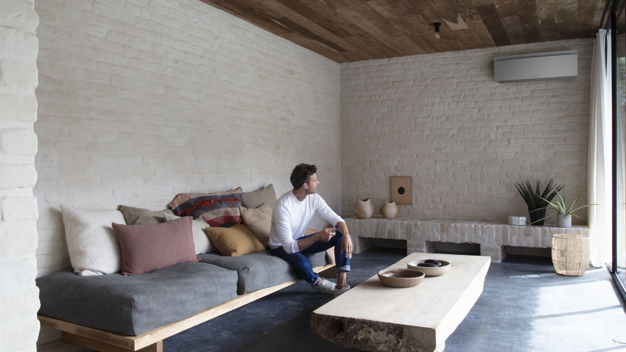 Installer putting a Stylish indoor unit on the wall