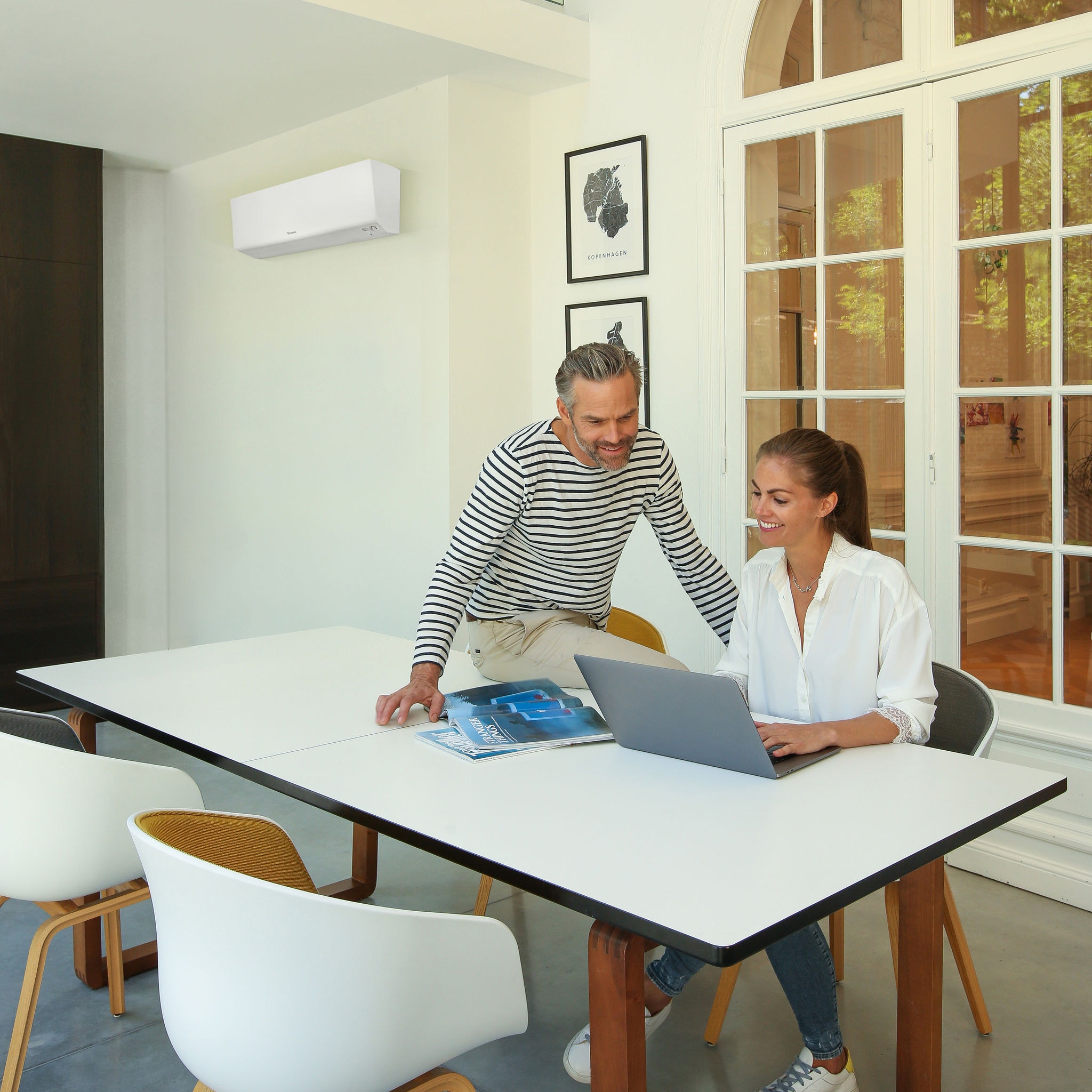 Lady and Man at desk by computer Daikin Perfera in background