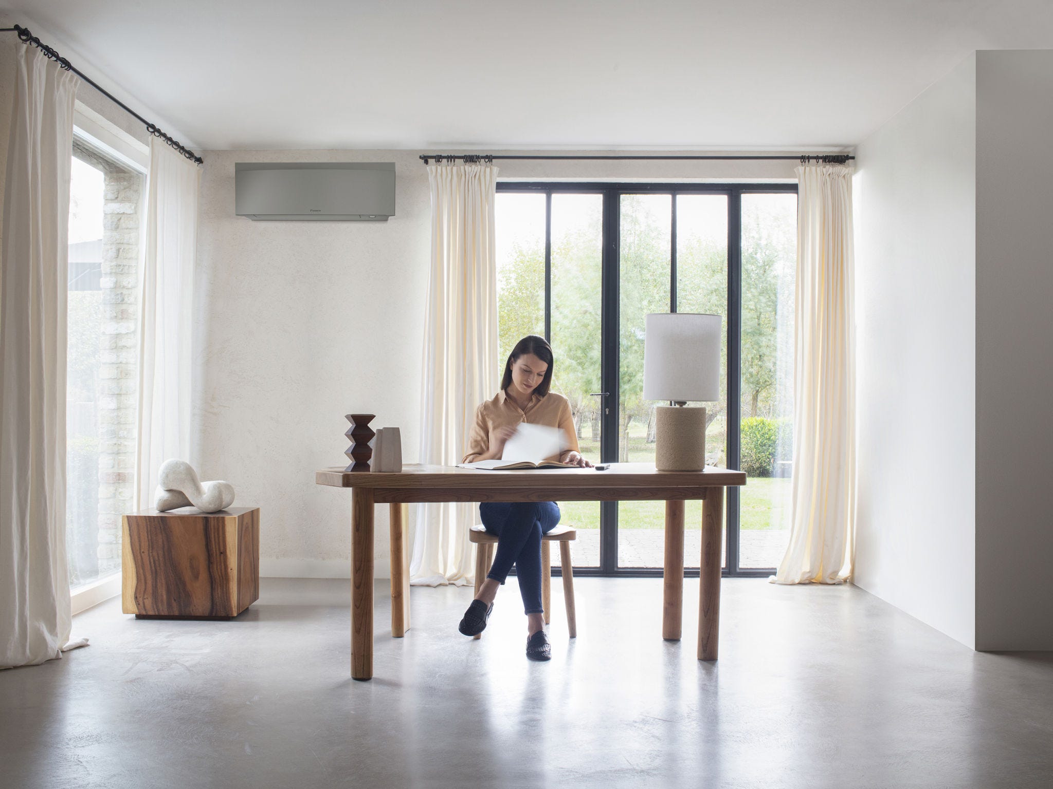 lady at desk in study Daikin Emura in background