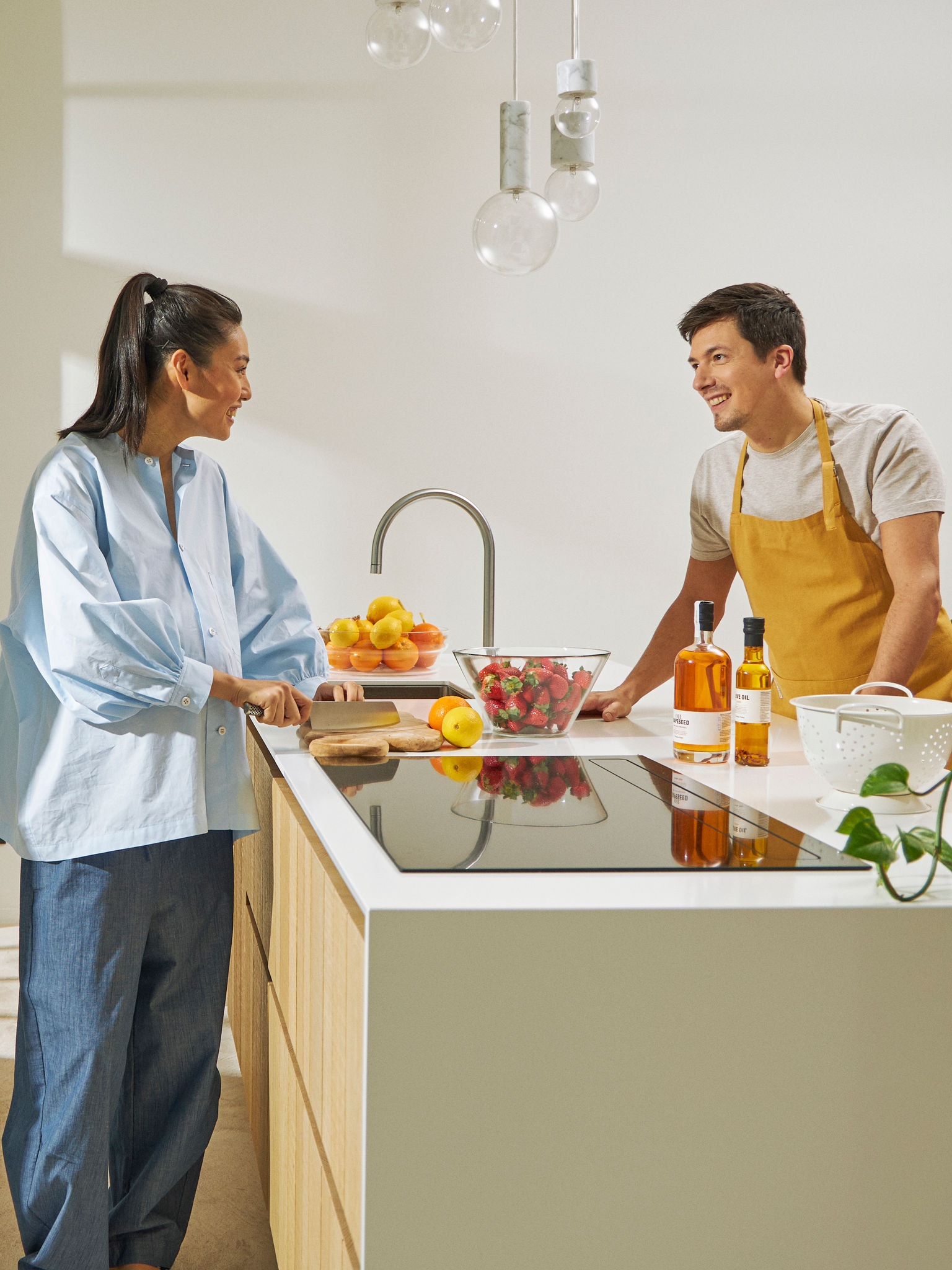 Pregnant couple cooking a meal together in the kitchen