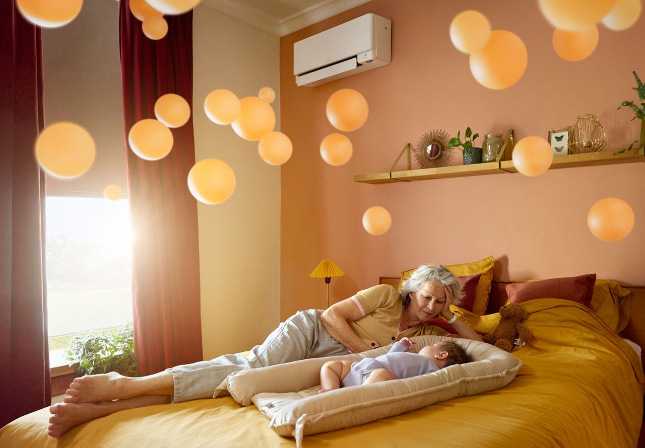 Woman watching sleeping baby on bed
